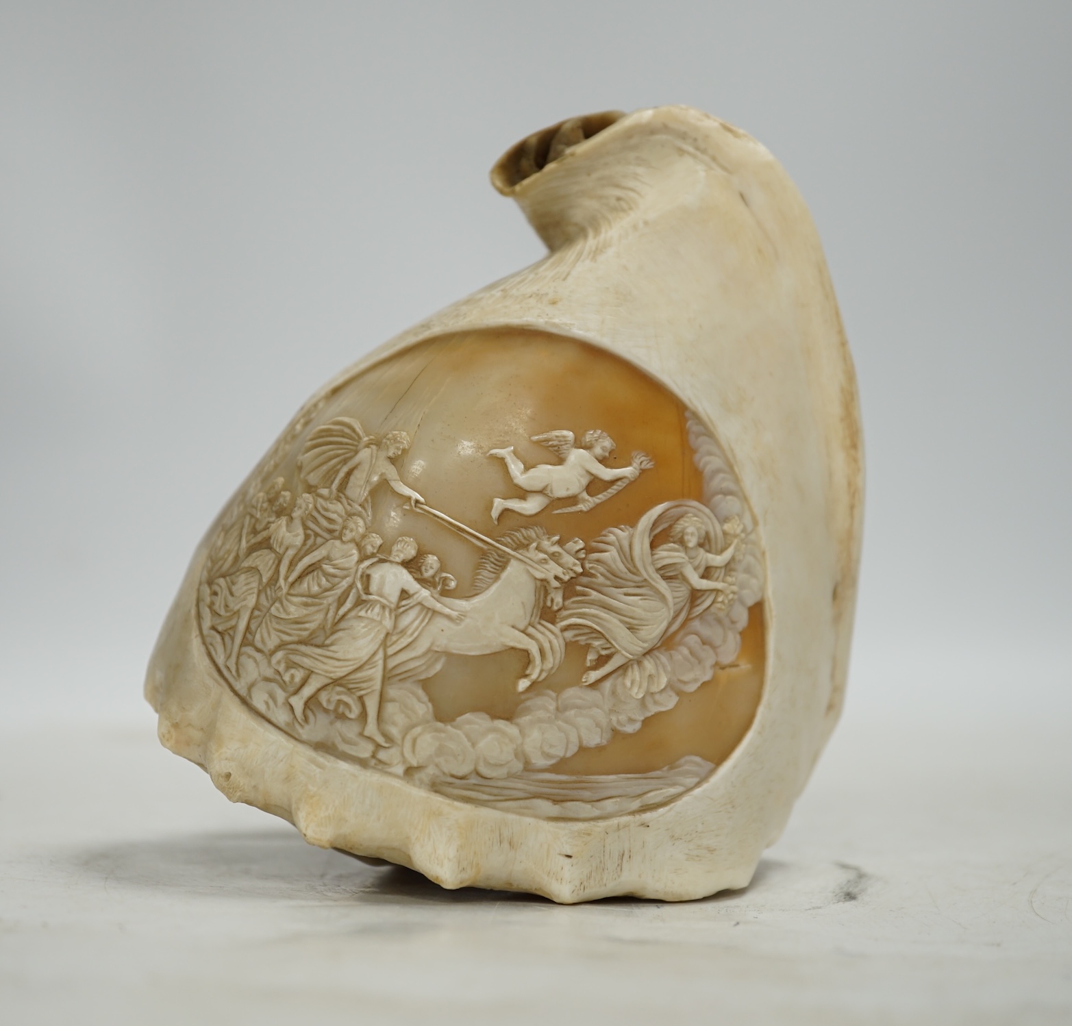A late 19th century Neapolitan conch shell cameo, carved with classical figures about a chariot, 13cm. Condition - fair
